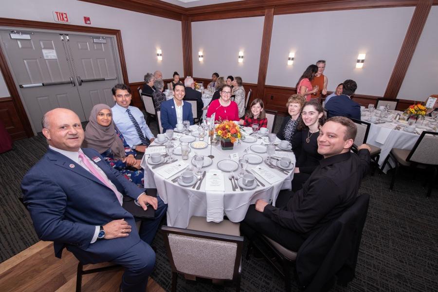 Institutional Advancement, ACPHS staff and alumni sit together at alumni awards dinner